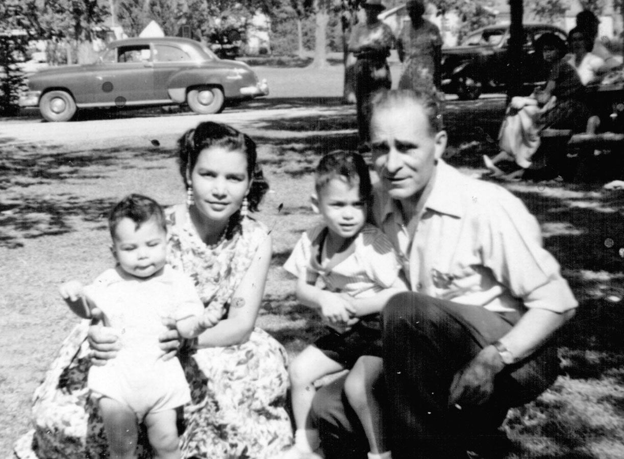 An old picture of Frankie's family posing in a park